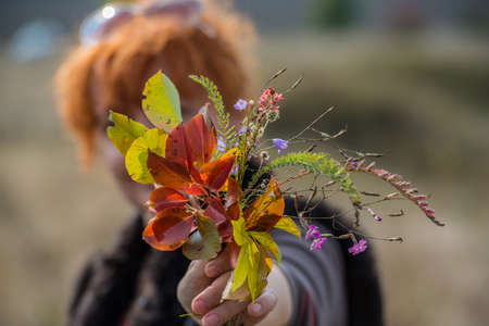 woman with a bouquet outdoors autumn colorsの写真素材
