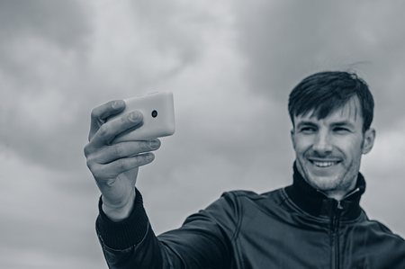 businessman doing selfie smartphone outdoorsの写真素材