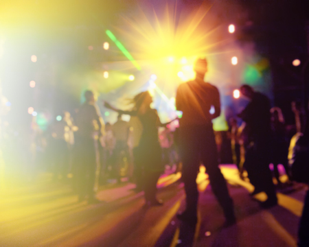 young people relaxing and having fun at a nightclub, blurred backgroundの写真素材