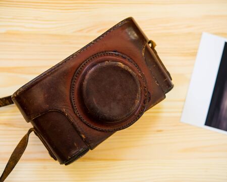 Photo and film camera in case on wooden tableの写真素材