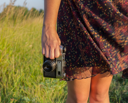 Girls legs and hand with  cameraの写真素材