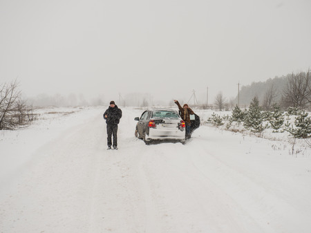 car stuck in the snow people are asking for help