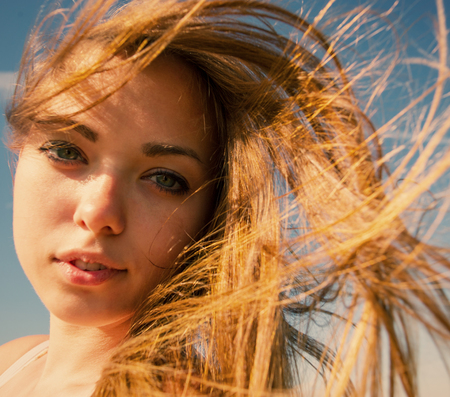 portrait of a pretty girl, and her hair fluttering in the windの写真素材