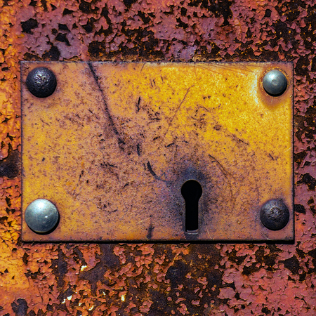 keyhole in old rusty metal gateの写真素材