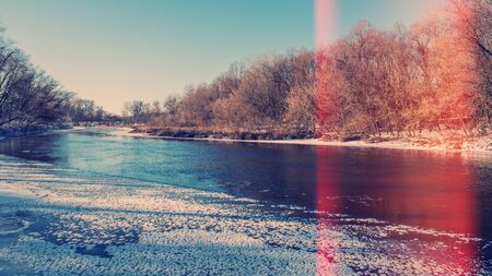 freezing river and forest on a sunny day,  landscape in the countrysideの写真素材