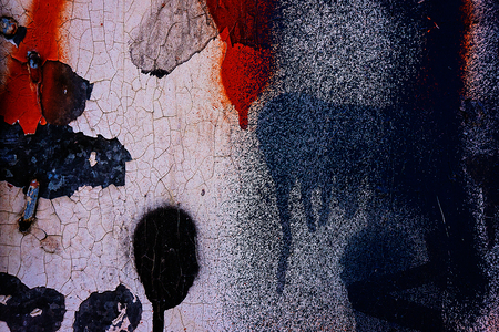 surface of the metal covered with old paint and fragments of graffitiの写真素材