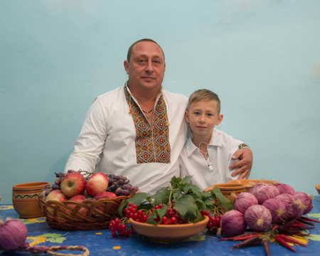 Portrait  of father and son in national embroidered indoors. Ukraine. Europe.の写真素材