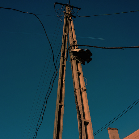 Pole of the power lines of communications on a blue sky backgroundの写真素材