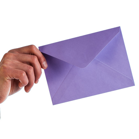 Businessman holds a lilac envelope isolated on a white backgroundの写真素材