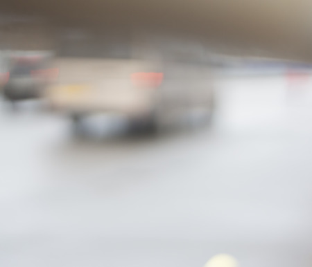 Cars are driving along the road.  Blurred light background. City. Urban.