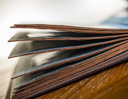 pages of an open old photo album on the table in the room. Old book. Retro. Closeup.の写真素材