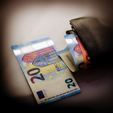 paper euro notes and an old wallet. Twenty and ten euros. Currency of the European Union.の写真素材