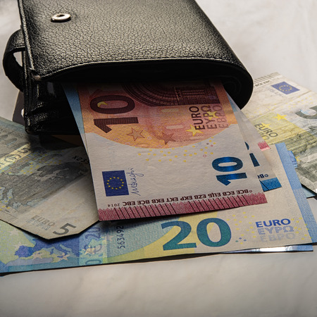 paper euro notes and an old wallet. Five, twenty and ten euros. Currency of the European Union.