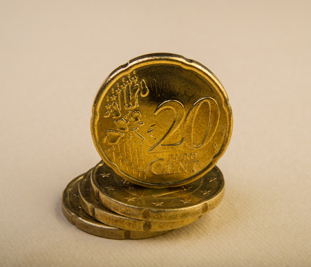 Twenty euro cent coins lie on a pile of coins. Coins on the blurred background. Currency of the European Union.の写真素材