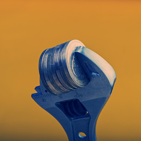 stack of euro coins is clamped. The concept of financial crisis or inflation.  Euro money. Currency of the European Union.の写真素材