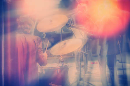 Drum set, music and jazz band concept. A musician playing with chopsticks on percussion instruments. Blurred background.の写真素材