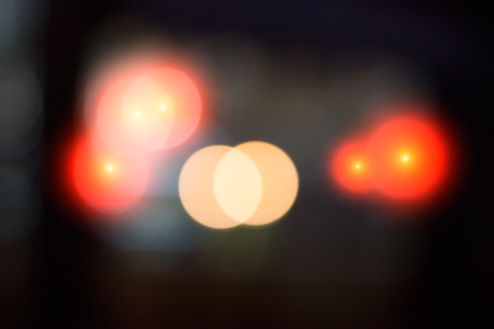 Abstract blurred background. Multicolored light spots on a dark background.
