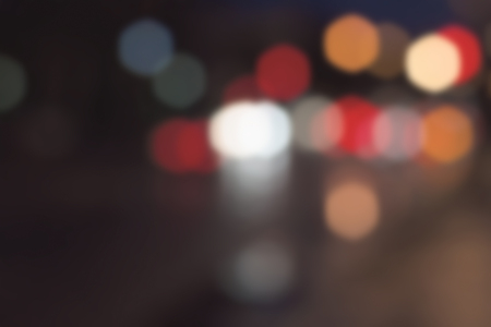 Abstract blurred background. Multicolored light spots on a dark background.