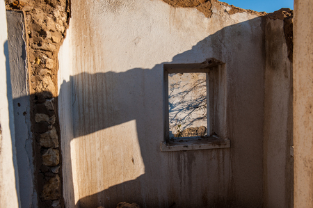 DESTROYED FORGED OLD HOUSE IN THE RURAL LOCATION. REMAINS OF WALLS AND WINDOWS.の写真素材