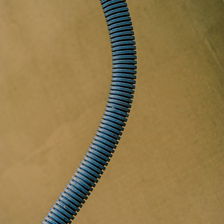 Isolation Corrugation Pipe for electrical wiring against the wall background. Organization of an electronic network.の写真素材