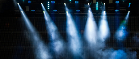 Lighting the stage during a musical rock concert and artificial fog. Web banner.