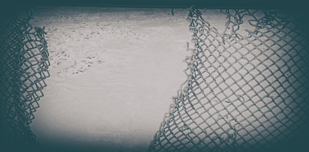 Broken old metal mesh against the snow. Web banner. Element of design.の写真素材