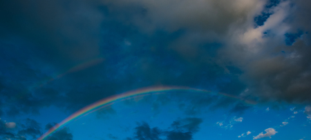 panorama, rainbow in the evening against the background of rain clouds. Web banner. Element of design.の写真素材