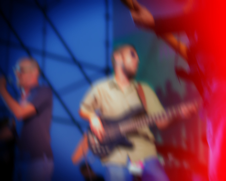 blur backgroubd, guitarist during a concert at night on a city street. Rock guitar player during performance.のeditorial素材