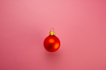 Christmas red ball on a pink background. Web design. For the blog.の写真素材