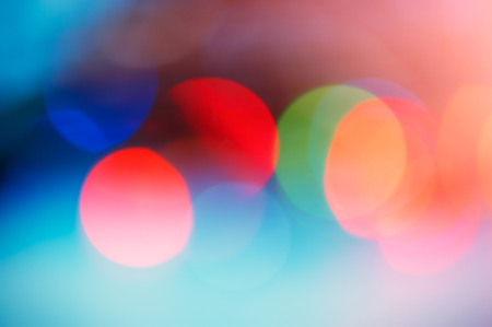 Abstract defocused festive background, red color spots. Blurred color background. For design.の写真素材