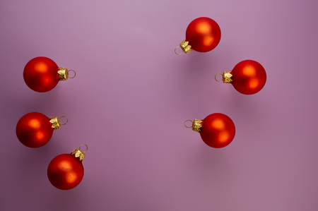 six red balls on a purple background. Christmas composition, winter season. For your design.の写真素材