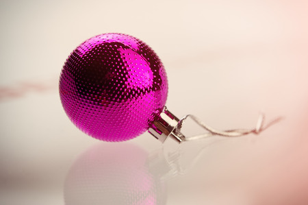 purple ball lies on the surface of the glass. Winter season.の写真素材