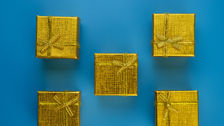 festive golden gift boxes on a blue background.Christmas composition.の写真素材