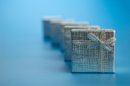 festive silver gift boxes on a blue background.Christmas composition.