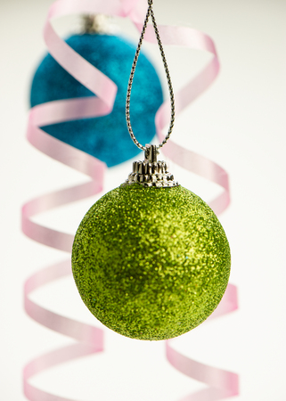 holiday balls and paper ribbons on a light background.Christmas composition.の写真素材