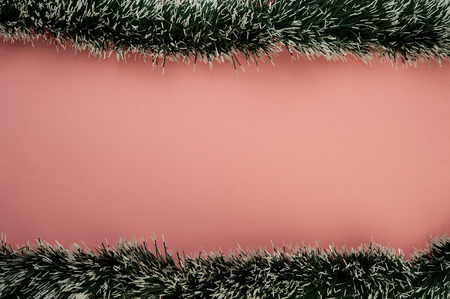 garland ornaments of green color on a pink background. Christmas composition. WEB BANNER.の写真素材