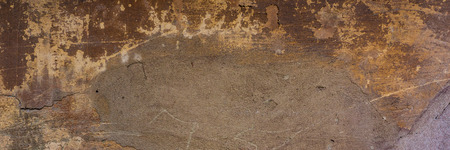 wall covered with old crumbling cement plaster with traces of paint. Web banner.の写真素材