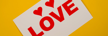 two hearts and the inscription love lies on a yellow background. Web banner for design.の写真素材