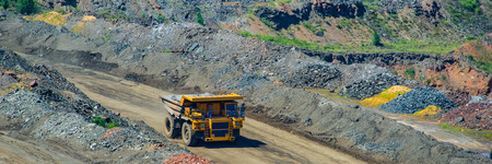 board iron ore pit and ore removal by road. Summer season. Web banner.