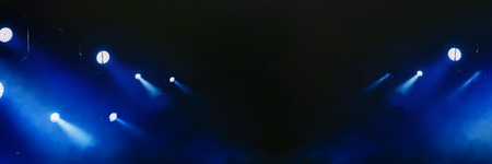 lighting with concert spotlights on a dark background during the show. Banner for design.