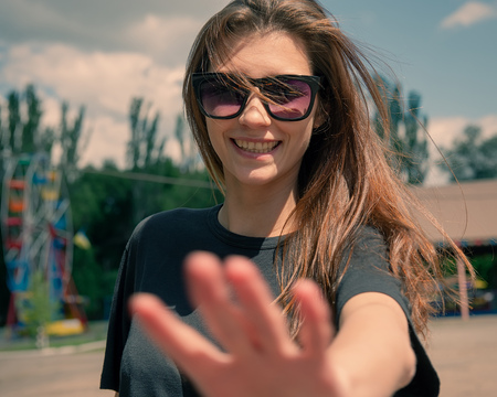Portrait of a girl making a forbidding hand gesture.