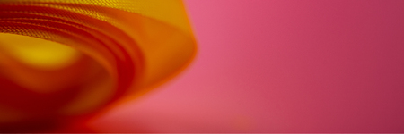 Yellow ribbon lies on a pink background. Web banner.