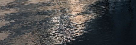 waves on the surface of the water in the river and sun glare. Web banner for your design.の写真素材