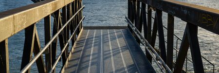 metal bridge for mooring of river vessels. Web banner.の写真素材