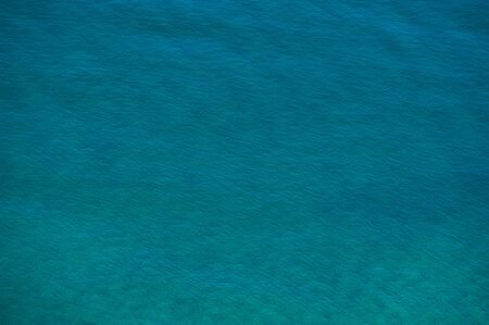 water surface in the sea on a sunny day in shallow water. Summer season, august.