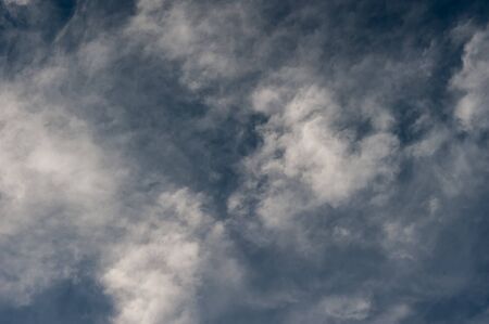 white clouds on a background of blue sky on a sunny day. Summer season, august.