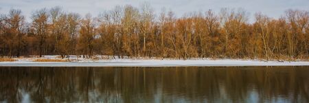 Deciduous Forest, Water and Ice on the River Bank. Winter Season, February. Web Banner. Natural...