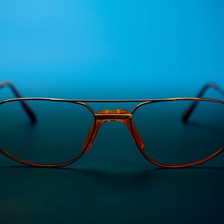 frame of the glasses lies on a dark blue background. Web banner.