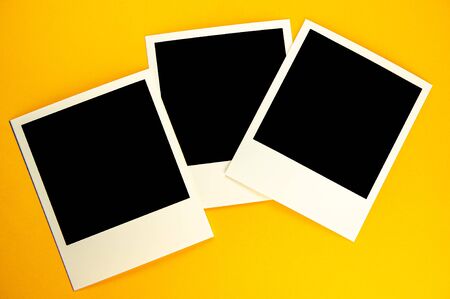 Three photos with the image of a black square lie on a yellow background. For your design.の写真素材