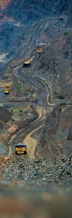 Removal of Iron Ore from the Quarry by Trucks. Industrial Landscape. Vertical Web Banner.
